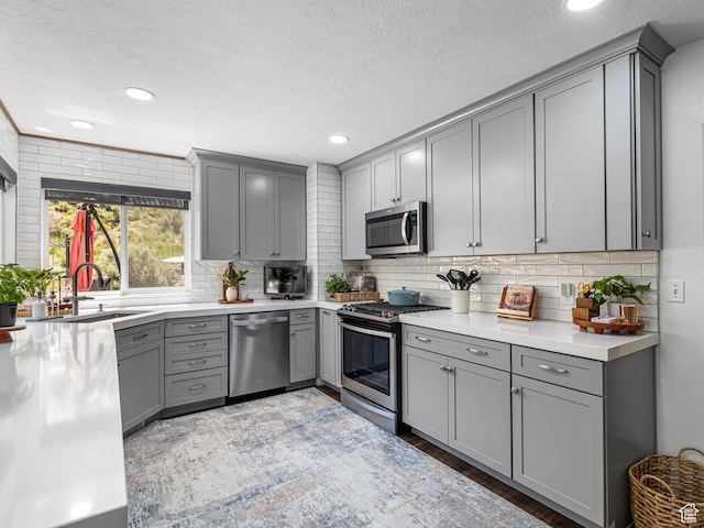 1152 E Gavin Cir, Draper, UT 84020 - kitchen with gray cabinetry, stainless steel appliances, a sink, decorative backsplash, and recessed lighting