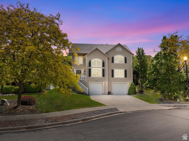 1152 E Gavin Cir, Draper, UT 84020 - view of front of property with concrete driveway, stucco siding, a front lawn, an attached garage, and stairway