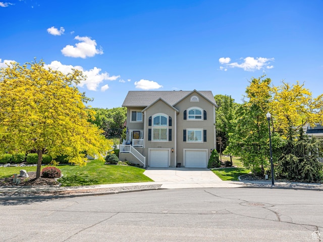 1152 E Gavin Cir, Draper, UT 84020 - view of front of property with concrete driveway, a garage, stucco siding, stairway, and a front yard
