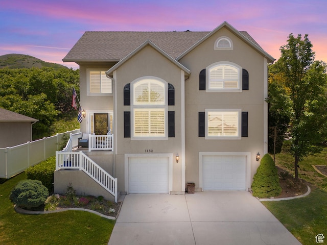 1152 E Gavin Cir, Draper, UT 84020 - view of front of house with driveway, a garage, stucco siding, and a front lawn