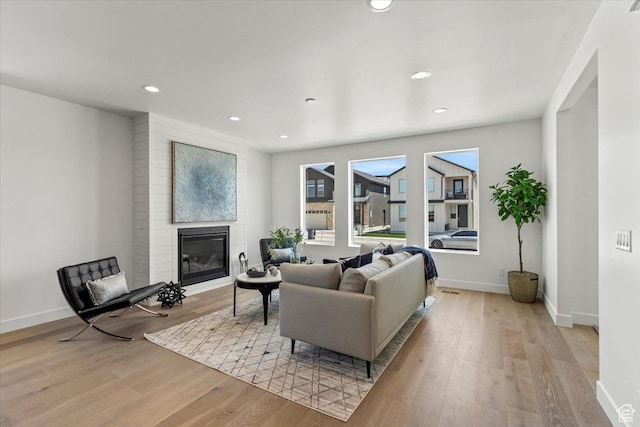 7119 S Rocky Trl Unit 102, West Jordan, UT 84084 - living area featuring a large fireplace, light wood finished floors, baseboards, and recessed lighting