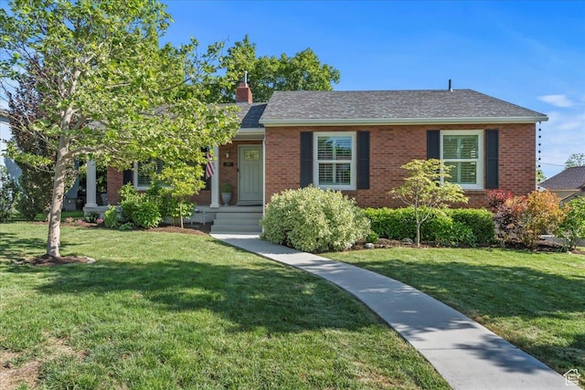 2266 E Kensington Ave, Salt Lake City, UT 84108 - view of front facade featuring a front lawn, brick siding, and a chimney