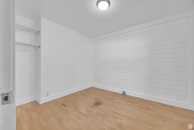 1054 E Lamplighter Dr, River Heights, UT 84321 - unfurnished bedroom featuring baseboards, a textured ceiling, and wood finished floors