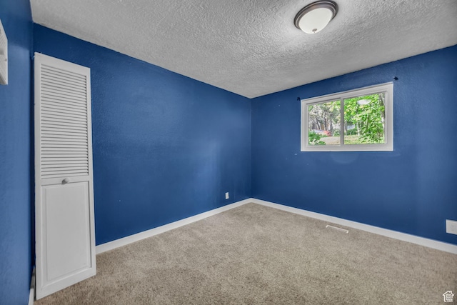 1054 E Lamplighter Dr, River Heights, UT 84321 - carpeted empty room featuring a textured ceiling and baseboards