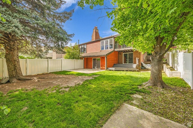 1054 E Lamplighter Dr, River Heights, UT 84321 - back of property with a patio and a chimney