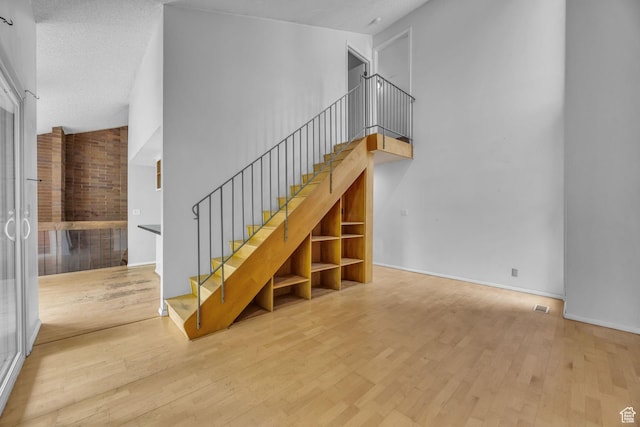 1054 E Lamplighter Dr, River Heights, UT 84321 - stairs featuring hardwood / wood-style floors and baseboards