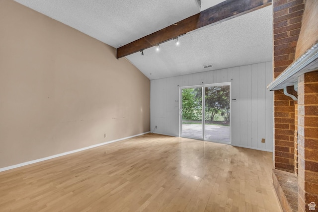 1054 E Lamplighter Dr, River Heights, UT 84321 - unfurnished living room with light wood-style floors, baseboards, wood walls, and a textured ceiling