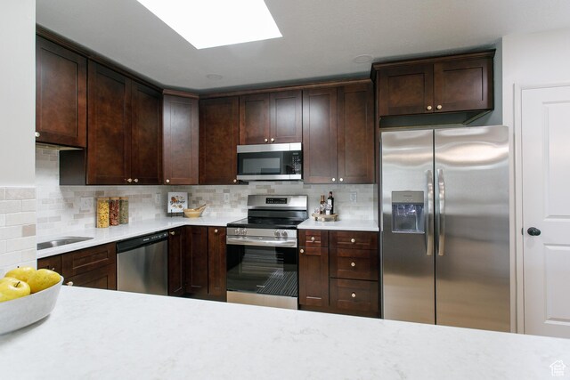 3644 S 860 E Unit 57, Salt Lake City, UT 84106 - kitchen featuring appliances with stainless steel finishes, light countertops, and decorative backsplash