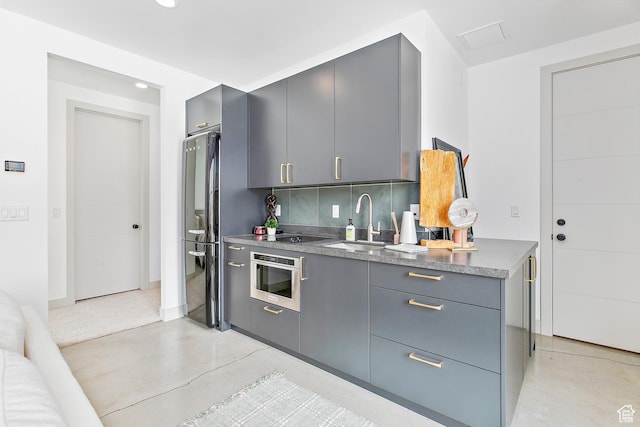 1620 W Brevia Ct Unit 25, Lehi, UT 84043 - kitchen featuring gray cabinets, oven, a sink, freestanding refrigerator, and tasteful backsplash