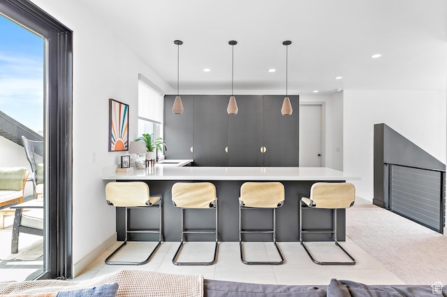 1620 W Brevia Ct Unit 25, Lehi, UT 84043 - kitchen featuring a kitchen bar, a sink, light countertops, a peninsula, and recessed lighting