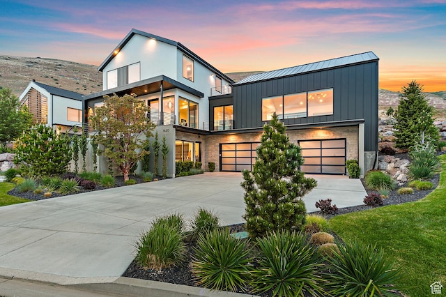 1620 W Brevia Ct Unit 25, Lehi, UT 84043 - contemporary house with a garage, driveway, a standing seam roof, a balcony, and board and batten siding
