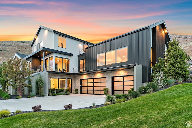 1620 W Brevia Ct Unit 25, Lehi, UT 84043 - modern home featuring a garage, a balcony, a front lawn, driveway, and board and batten siding