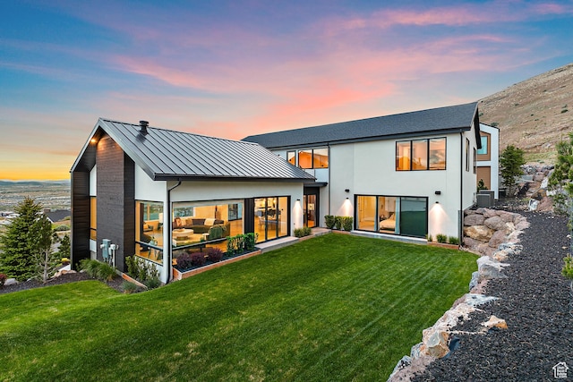1620 W Brevia Ct Unit 25, Lehi, UT 84043 - rear view of property featuring a standing seam roof, a lawn, metal roof, and stucco siding
