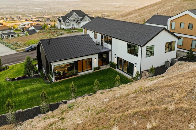 1620 W Brevia Ct Unit 25, Lehi, UT 84043 - back of property with stucco siding, a residential view, metal roof, a lawn, and cooling unit