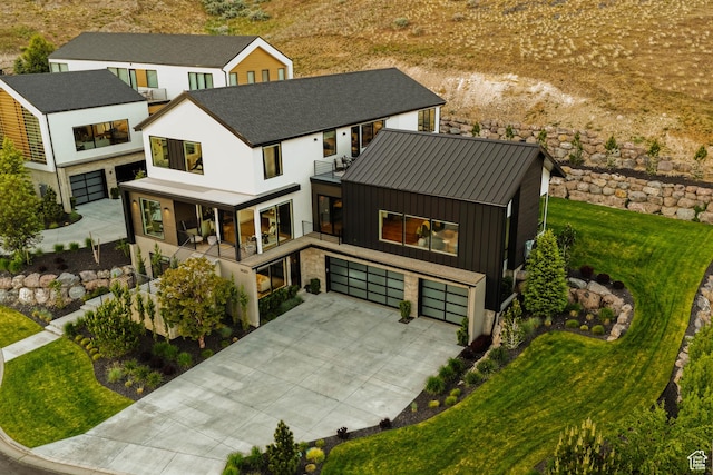 1620 W Brevia Ct Unit 25, Lehi, UT 84043 - view of front of home featuring a garage, a balcony, driveway, a front yard, and a standing seam roof