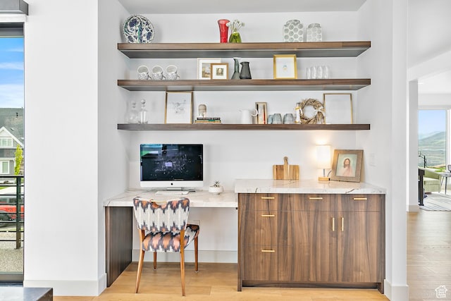 1620 W Brevia Ct Unit 25, Lehi, UT 84043 - bar with built in study area, light wood-type flooring, and baseboards