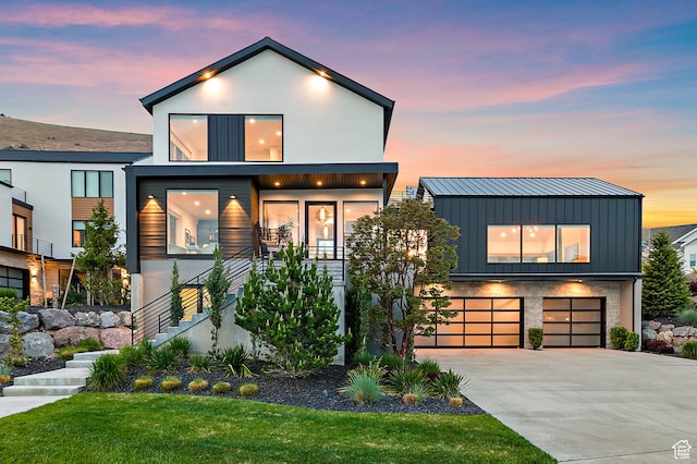 1620 W Brevia Ct Unit 25, Lehi, UT 84043 - contemporary home with stairs, board and batten siding, concrete driveway, a garage, and a standing seam roof