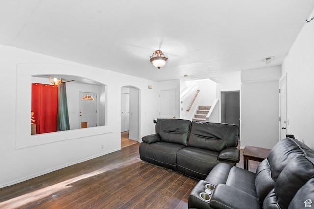 444 E 670 N, Tooele, UT 84074 - living area with arched walkways, dark wood finished floors, stairway, and baseboards