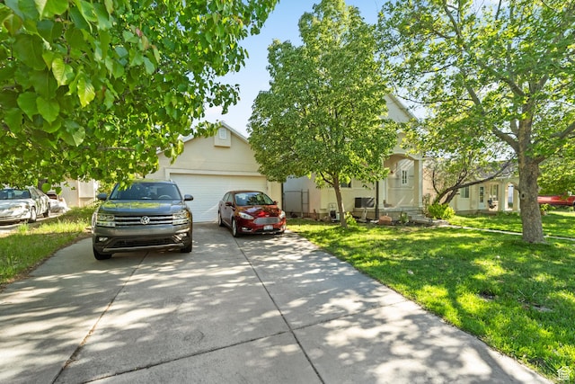 444 E 670 N, Tooele, UT 84074 - view of property hidden behind natural elements with driveway, a front yard, an attached garage, and stucco siding