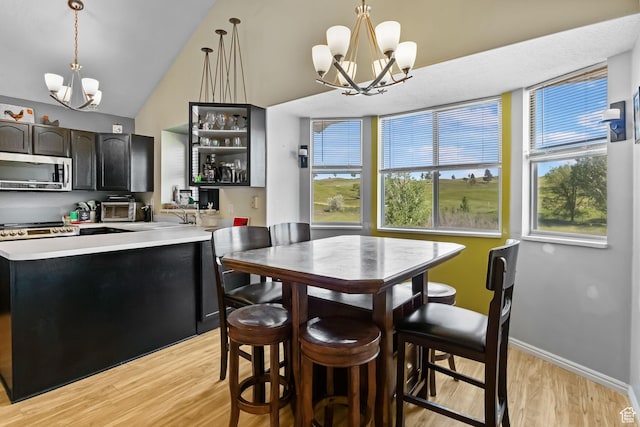 1367 E 3125 N, Layton, UT 84040 - dining room featuring a chandelier, light wood-style floors, baseboards, and vaulted ceiling