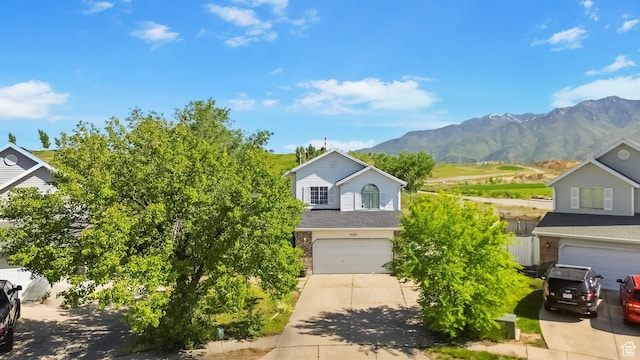 1367 E 3125 N, Layton, UT 84040 - view of property hidden behind natural elements featuring driveway, a garage, and a mountain view