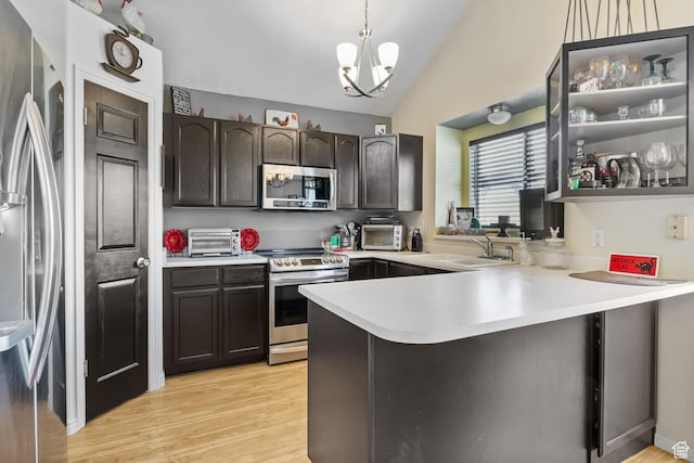 1367 E 3125 N, Layton, UT 84040 - kitchen with stainless steel appliances, a sink, light countertops, a peninsula, and lofted ceiling