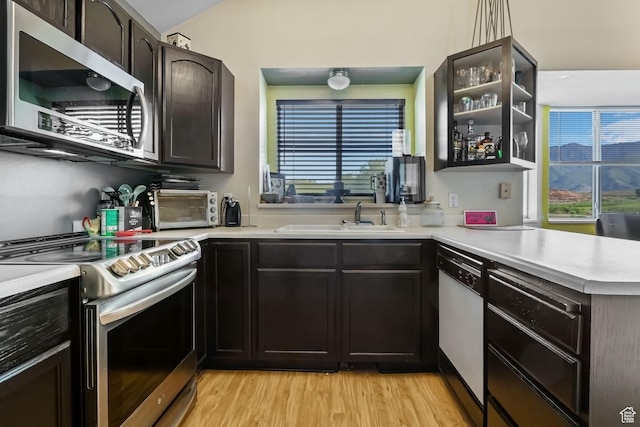 1367 E 3125 N, Layton, UT 84040 - kitchen featuring appliances with stainless steel finishes, a sink, light wood-style floors, light countertops, and plenty of natural light