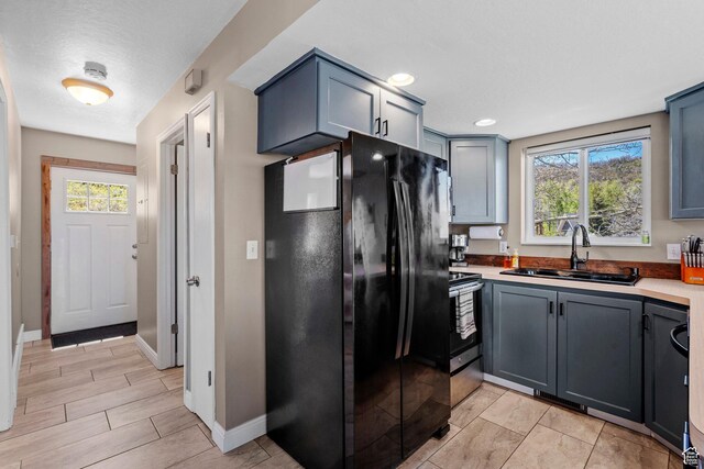 10246 E Lake Pines Dr Unit 1020, Heber City, UT 84032 - kitchen with freestanding refrigerator, a sink, baseboards, light countertops, and gray cabinets