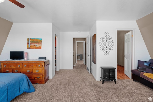 10246 E Lake Pines Dr Unit 1020, Heber City, UT 84032 - bedroom with light carpet, baseboards, a ceiling fan, and a wood stove