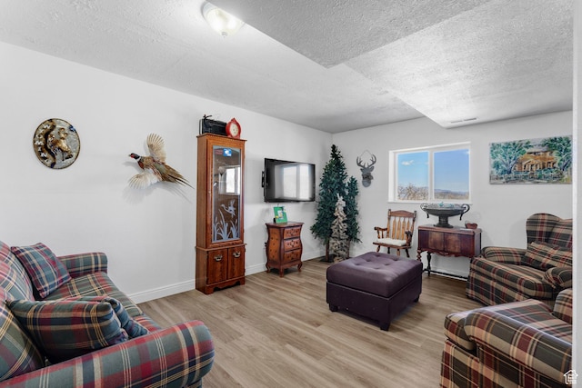 10246 E Lake Pines Dr Unit 1020, Heber City, UT 84032 - living area featuring a textured ceiling, light wood finished floors, and baseboards