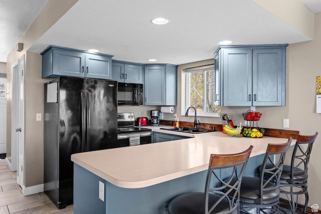 10246 E Lake Pines Dr Unit 1020, Heber City, UT 84032 - kitchen featuring black appliances, a sink, a peninsula, light countertops, and blue cabinets