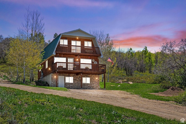 10246 E Lake Pines Dr Unit 1020, Heber City, UT 84032 - view of front facade featuring a gambrel roof, stone siding, metal roof, a deck, and driveway