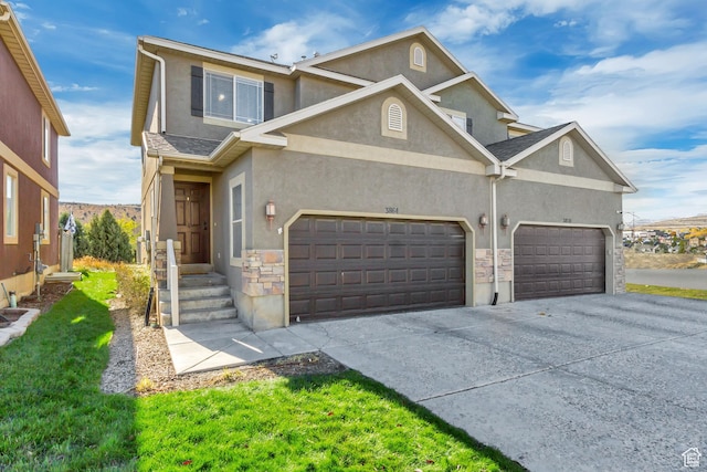 3864 E Cascade Rd, Eagle Mountain, UT 84005 - view of front facade featuring stucco siding, concrete driveway, an attached garage, and stone siding