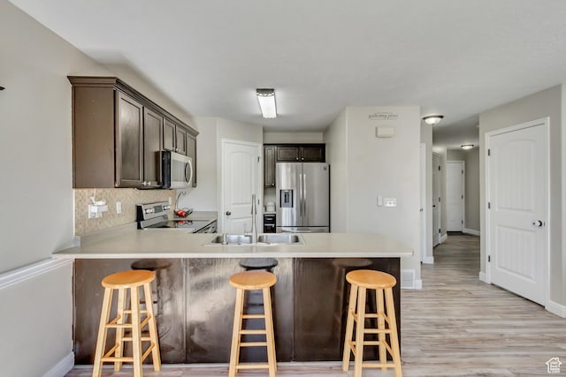 3864 E Cascade Rd, Eagle Mountain, UT 84005 - kitchen featuring appliances with stainless steel finishes, a sink, a peninsula, and baseboards