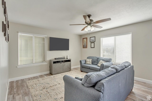 3864 E Cascade Rd, Eagle Mountain, UT 84005 - living room featuring ceiling fan, light wood-style floors, and baseboards