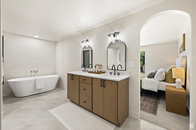 2559 E Evening Star Dr, Holladay, UT 84124 - bathroom featuring double vanity, a freestanding bath, connected bathroom, and baseboards
