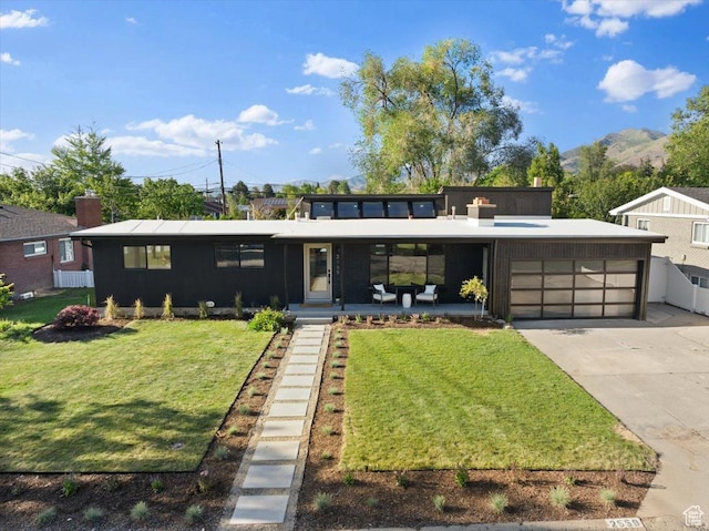 2559 E Evening Star Dr, Holladay, UT 84124 - view of front facade with a garage, a front yard, driveway, and a mountain view