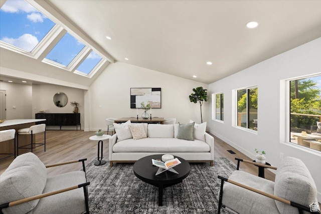 2559 E Evening Star Dr, Holladay, UT 84124 - living room featuring a skylight, vaulted ceiling, wood finished floors, recessed lighting, and baseboards