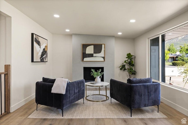 2559 E Evening Star Dr, Holladay, UT 84124 - living area featuring a fireplace, baseboards, wood finished floors, and recessed lighting