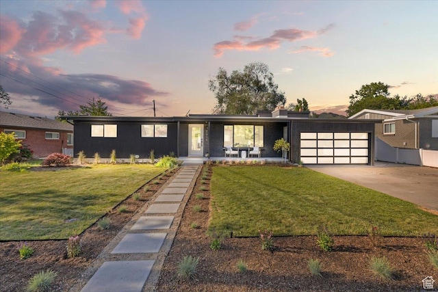 2559 E Evening Star Dr, Holladay, UT 84124 - view of front of house with an attached garage, a lawn, and driveway