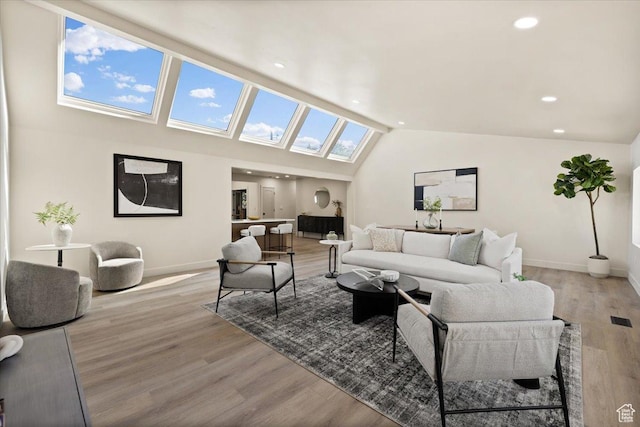2559 E Evening Star Dr, Holladay, UT 84124 - living room featuring a skylight, baseboards, light wood finished floors, vaulted ceiling, and recessed lighting