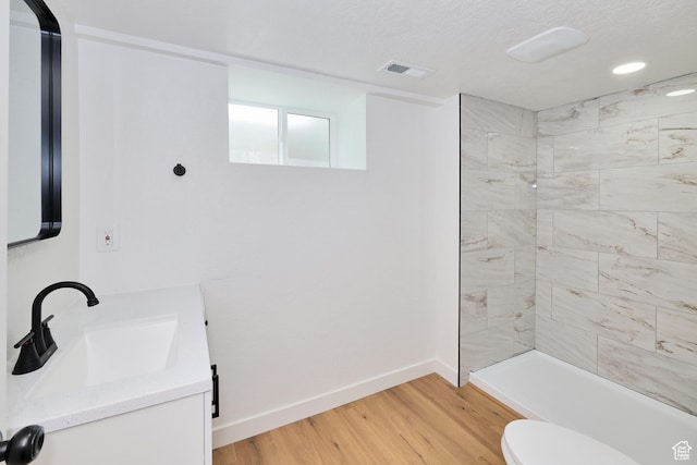 4673 W 5255 S, Kearns, UT 84118 - bathroom with vanity, a tile shower, wood finished floors, toilet, and baseboards
