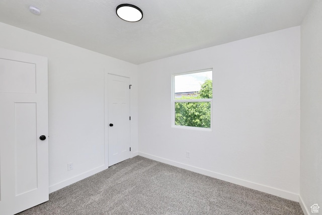 4673 W 5255 S, Kearns, UT 84118 - unfurnished bedroom featuring light carpet, baseboards, and a closet