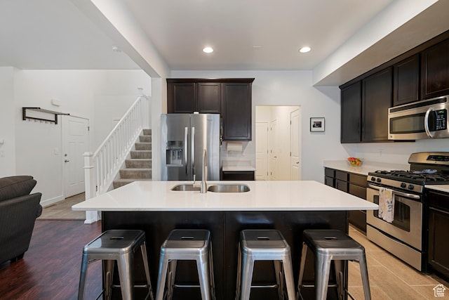 841 W Cannara Way S, Midvale, UT 84047 - kitchen with appliances with stainless steel finishes, a sink, a breakfast bar area, light countertops, and recessed lighting