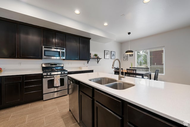 841 W Cannara Way S, Midvale, UT 84047 - kitchen with appliances with stainless steel finishes, a sink, light countertops, hanging light fixtures, and recessed lighting