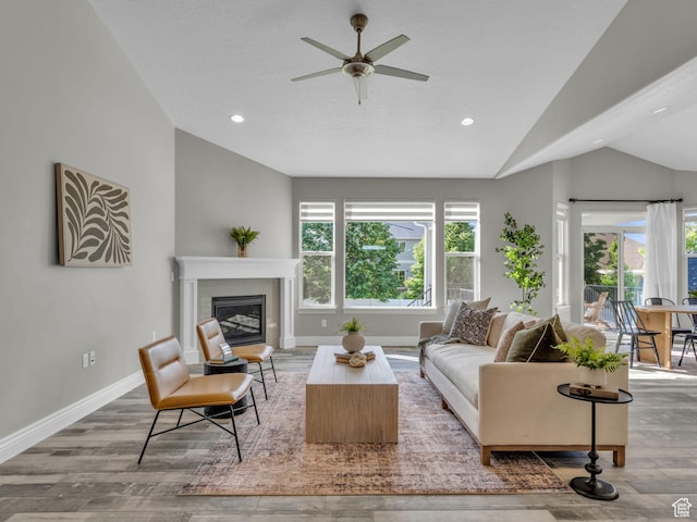 1949 W Shadow Way, Kaysville, UT 84037 - living room with lofted ceiling, healthy amount of natural light, wood finished floors, ceiling fan, and a glass covered fireplace
