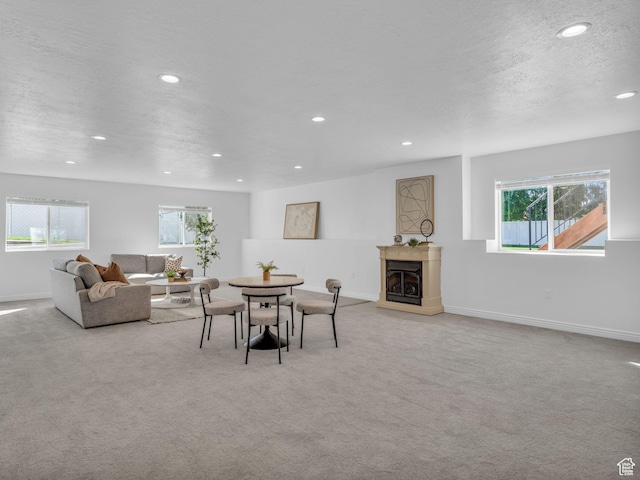 1949 W Shadow Way, Kaysville, UT 84037 - dining area with a fireplace with raised hearth, light carpet, recessed lighting, baseboards, and a textured ceiling