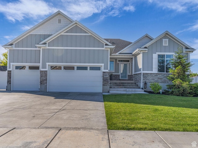 1949 W Shadow Way, Kaysville, UT 84037 - view of front of property featuring board and batten siding, stone siding, a garage, and a front yard