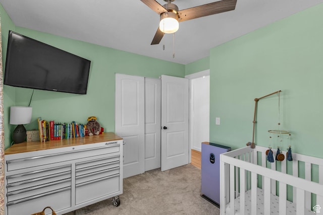 6169 Longmore Dr, Salt Lake City, UT 84118 - bedroom with light colored carpet, a ceiling fan, and a crib