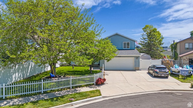 6169 Longmore Dr, Salt Lake City, UT 84118 - obstructed view of property featuring an attached garage, concrete driveway, and a fenced front yard